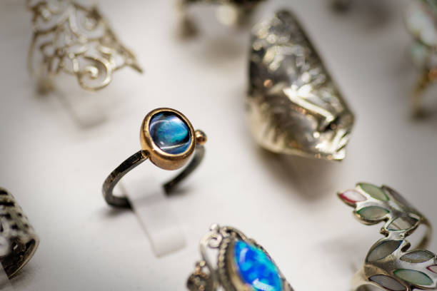 A detailed close-up of a blue gemstone ring with elegant metal design, showcasing fine craftsmanship and luxurious style
