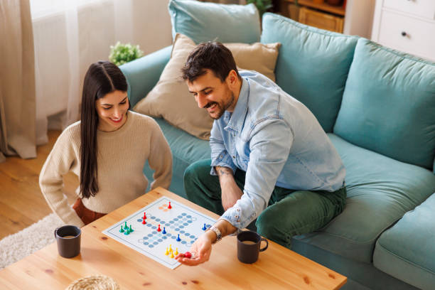 istock Couple playing ludo board game 2197371067