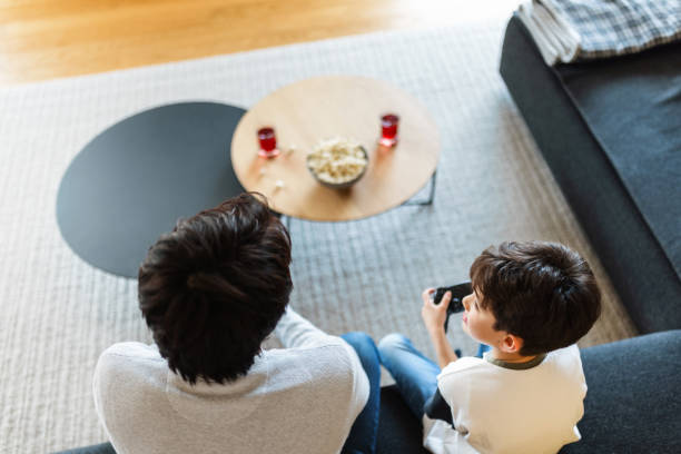 istock Father and Son Enjoy Quality Time at Home Playing Games 2197371495