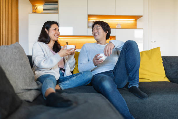 istock Japanese Couple Relaxing at Home on Sofa 2197371530