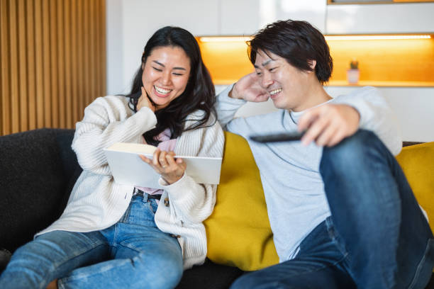 istock Joyful Japanese Couple Relaxing at Home 2197371538