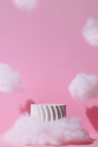 istock Premium scene. A white geometric podium in clouds on a pink background for the presentation of a cosmetic product. Showcase, display case. 2197372524