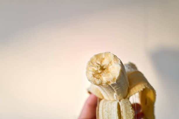 Close-up of a partially peeled banana, revealing its soft and edible interior