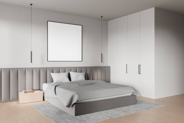 istock Modern bedroom with a blank poster on the wall, featuring a bed and minimalist decor. Perfect for mockup and interior design concepts. 3D Rendering 2197373553