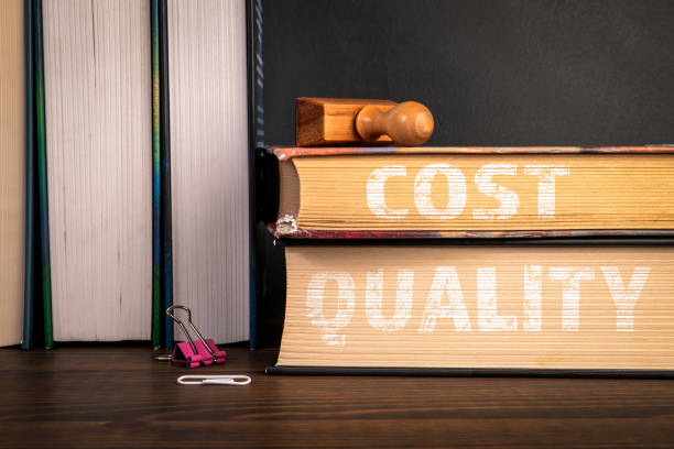 istock Cost and Quality.  A stack of books on a wooden shelf 2197375026