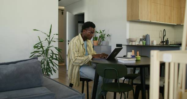 istock A man uses a laptop at home 2197375423
