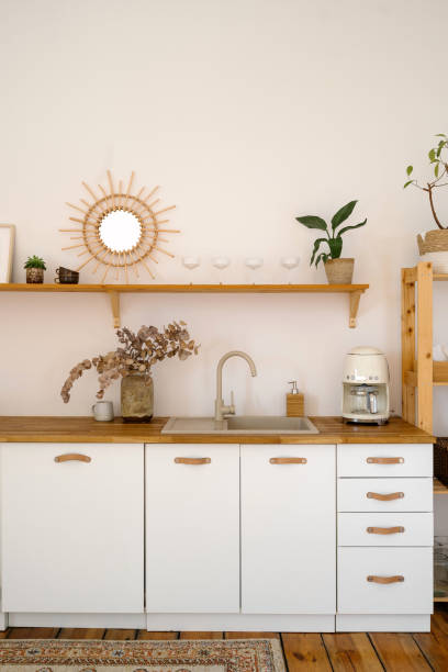 istock Stylish boho kitchen with wooden accents and minimalist design elements 2197377664