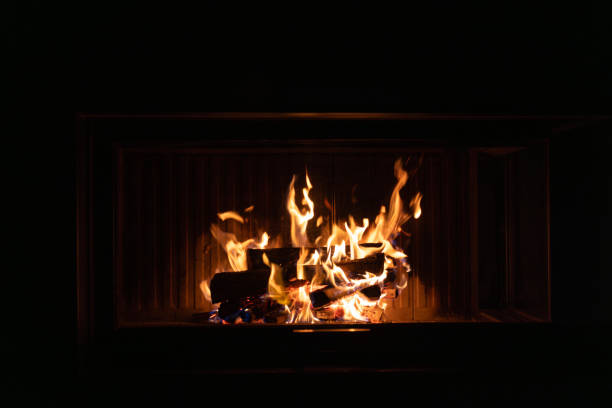 A warm and glowing fireplace with flames dancing over firewood, creating a cozy and tranquil indoor ambiance. High quality photo