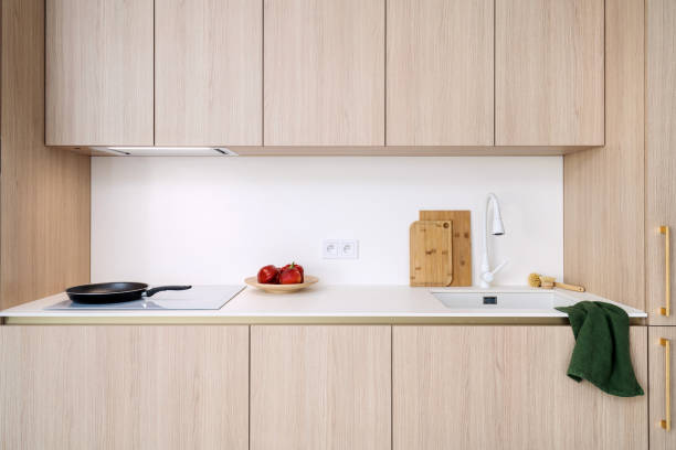 Minimalist kitchen design featuring modern induction hob and wooden accents