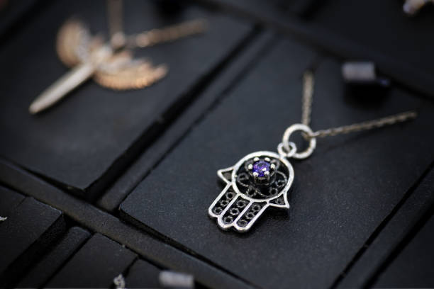 Woman holding necklace with Star of David