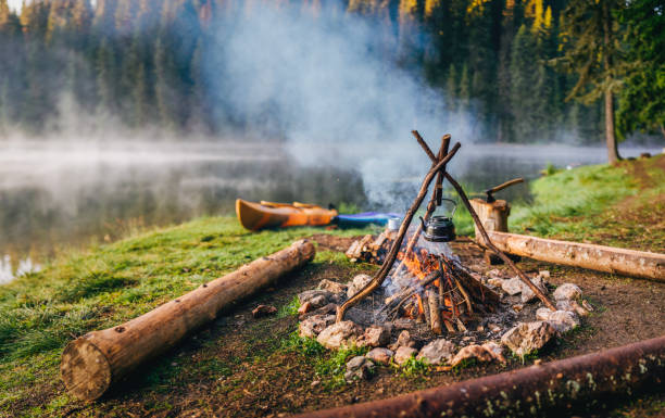 istock Warm and inviting campsite with a vintage teapot in focus. 2197388175
