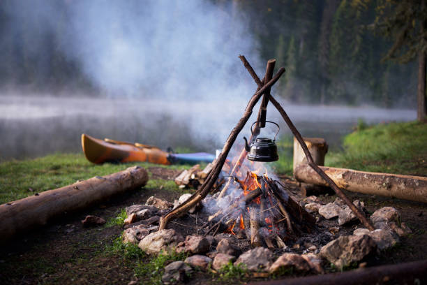 istock Nostalgic camping moment: a vintage teapot by the lake. 2197388187