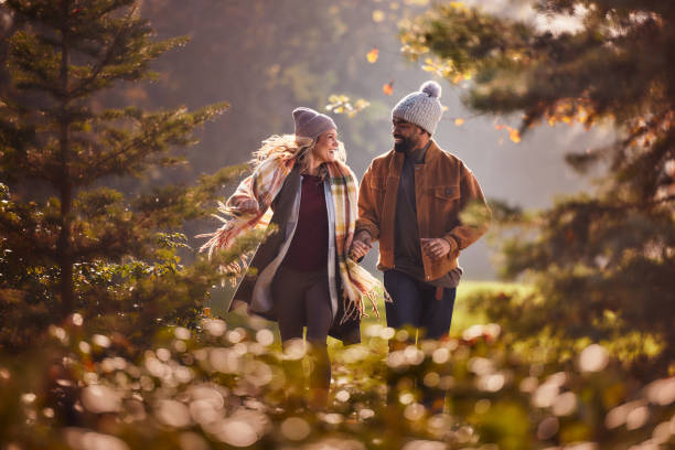 istock Carefree couple having fun while running in autumn day. 2197391428