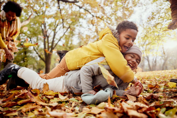 istock Happy black siblings having fun during autumn day in nature. 2197391966