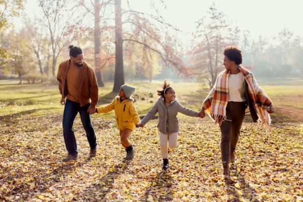 istock Playful black family having fun while running in autumn day. 2197392736