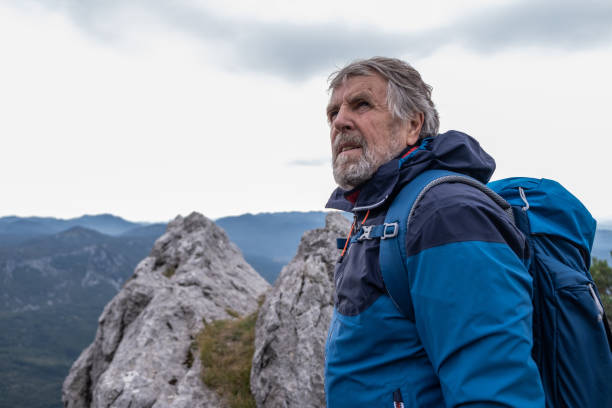 istock Senior man hiking high up in Mountains 2197393504