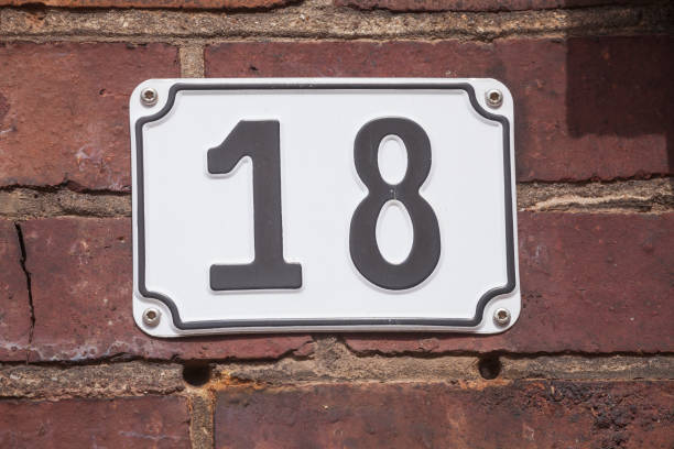 House license plate number 18 on a brick wall, Germany