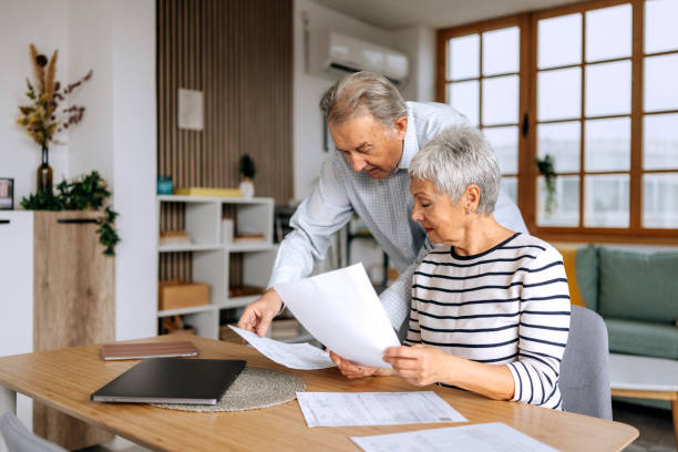 istock Senior couple planning their budget or going over bills at home 2197394353
