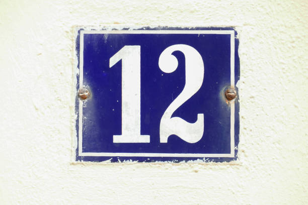 istock Blue house license plate number 12 on white background, Germany 2197394364