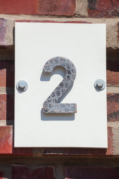 istock House license plate number 2 on a brick wall, Germany 2197394432