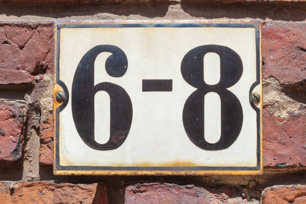 istock House license plate number 6 -8 on a brick wall, Germany 2197394580