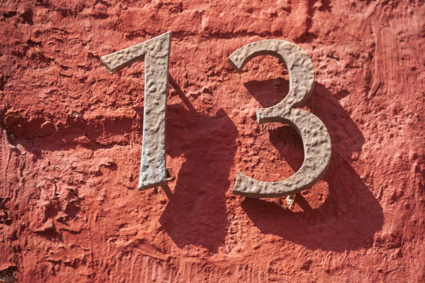 istock House license plate number 13 on a red brick wall, Superstition, Germany 2197394728