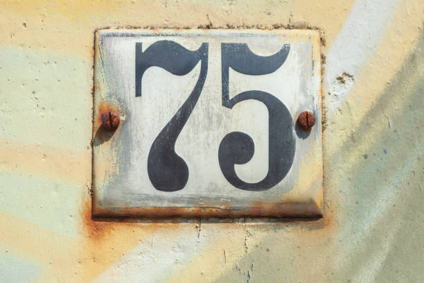 istock Old house license plate number 75 on house wall, Germany 2197394748