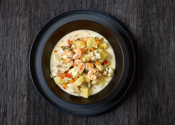 istock seafood chowder in a white bowl, top view 2197397050