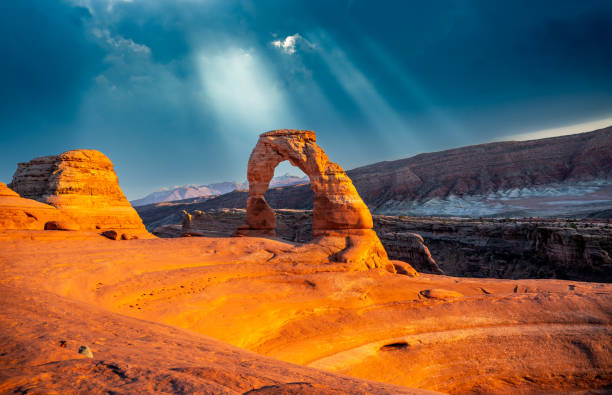Experience the breathtaking sunset at Delicate Arch in Arches National Park, Utah, with vibrant skies illuminating the iconic sandstone formation. This stunning natural wonder showcases the beauty of the American Southwest’s rugged desert landscape and dramatic rock formations.