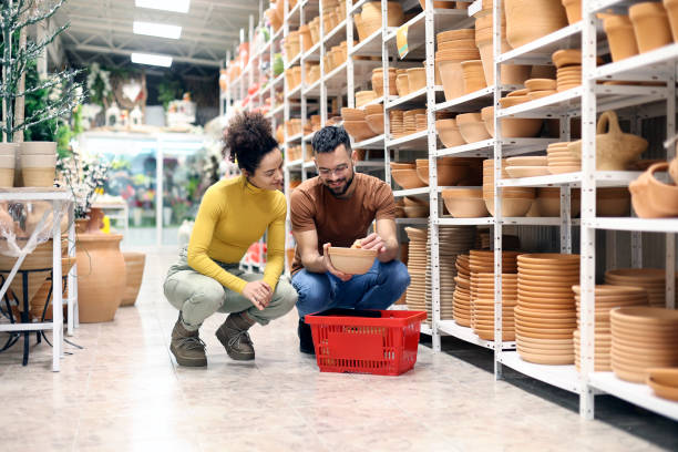 istock Young couple choosing a flower pot 2197399595