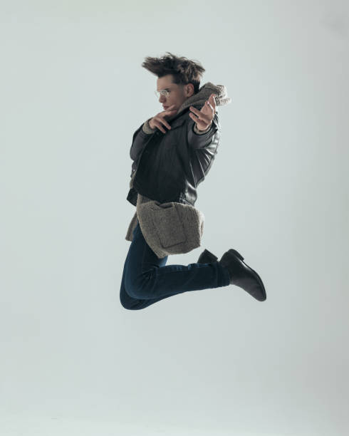 istock side view of cool dynamic guy jumping in the air and pointing fingers ahead 2197402457