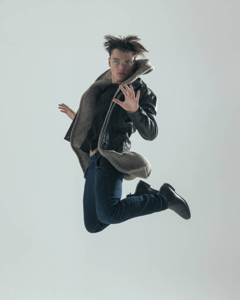 istock cool young guy leaping up in the air and being dynamic 2197402731