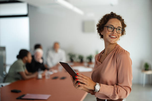 istock Glasses-wearing woman smiles in office environment. 2197402762