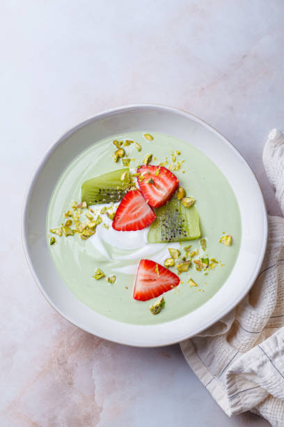 istock Green matcha yogurt with berries and pistachio. Vegan breakfast concept. 2197403485