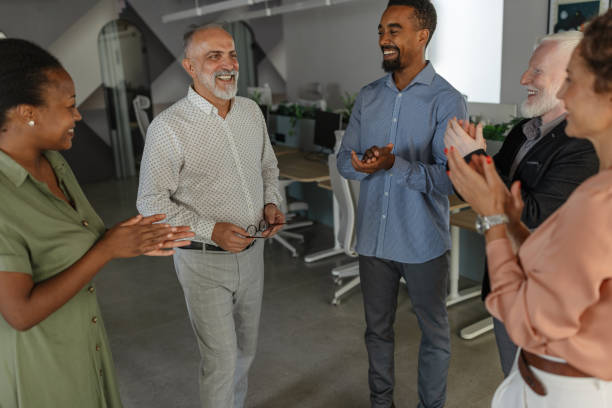 istock Team congratulates leader with applause and smiles. 2197403935