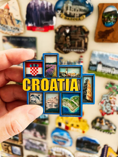 istock Hand holding Croatia fridge magnet with scenic designs and national emblem displayed 2197404167
