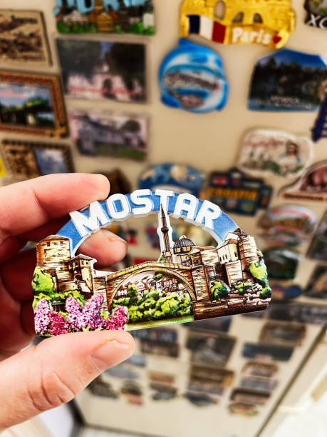 istock Hand holding a decorative souvenir featuring Mostar bridge design on fridge 2197404446