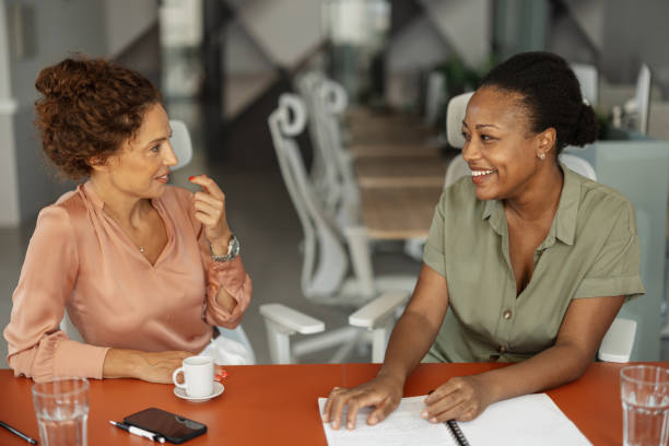 istock Two professional women sharing ideas and smiling. 2197404577