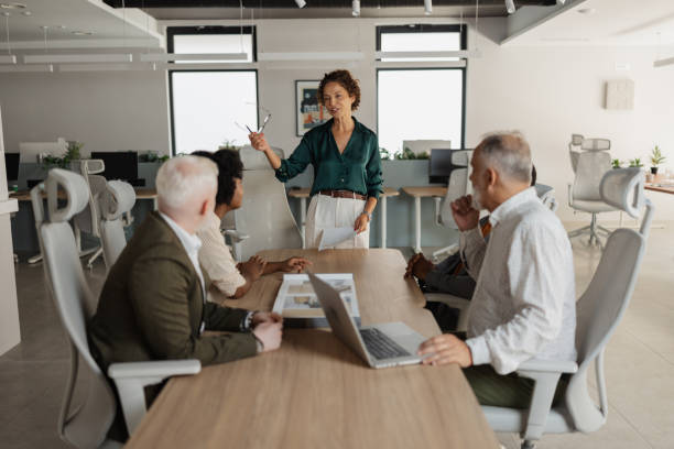 istock Leader presenting ideas to attentive team members. 2197405010