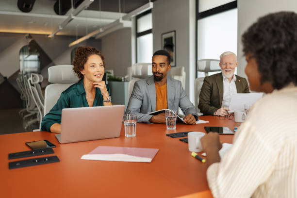 istock Team meeting in a stylish office with diverse staff. 2197405445