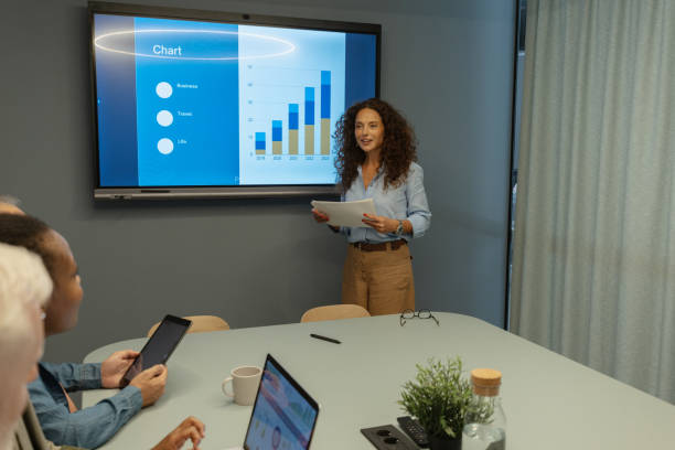istock Confident woman presents data trend charts at meeting. 2197406051