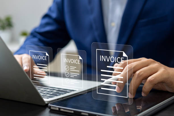 istock E-Invoice and Digital billing concept, Businessman using laptop to manage electronic statements on virtual screen. E-tax, Digital receipt, Online invoice processing and tax accounting solutions. 2197408251