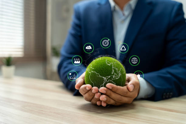 istock World environment day, Responsibility for a green planet, Sustainable growth, and global conservation.Businessman holding green world, Sustainable development goals and corporate social responsibility 2197410166