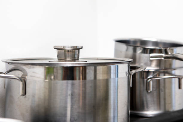 Silver-coloured pots and pans in a kitchen