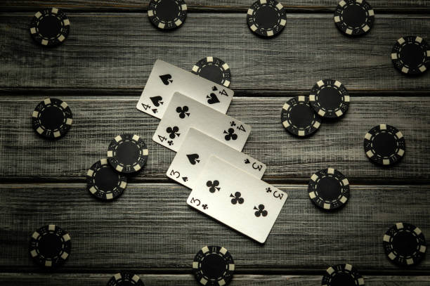 istock A thrilling poker game unfolds on a rustic wooden table, featuring a two pairs win combination and various poker chips scattered around, creating a tense atmosphere for the players 2197415792