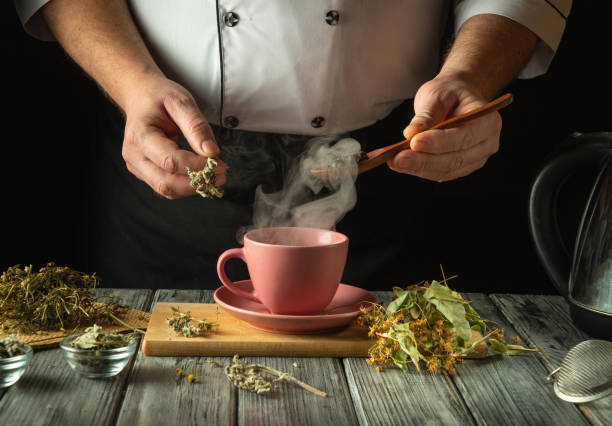 istock An experienced herbalist brews a healthy tea from medicinal dry herbs. A hand holds a spoon with dry rose hips to be added to a pink cup. Traditional medicine concept 2197415802