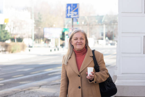 istock Mature woman with coffee walking 2197416707
