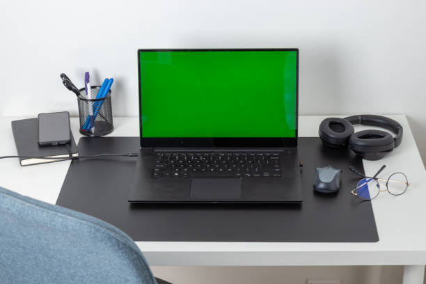 istock Workplace, laptop computer with blank empty green screen display monitor on desk. Mock up, copy space. Home office concept. Business, working from home, studying, e-learning, web site concept 2197417502