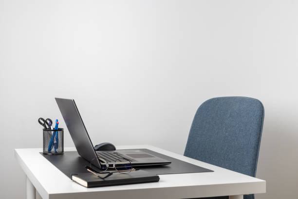istock Laptop computer, notebook, and eyeglasses and headphones on a desk, place for work and study, home freelancer's office 2197417794