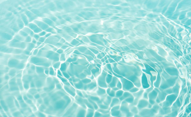 istock Blue water with ripples on the surface. Defocus blurred transparent blue colored clear calm water surface texture with splashes and bubbles. Water waves with shining pattern texture background. 2197417885